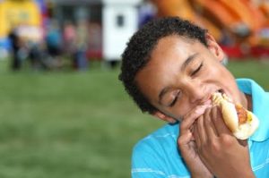 boy eating hot dog